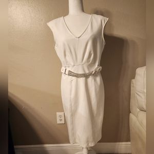 Off white strech j-lo dress. Built in shoulder pads. Silver chains across front.